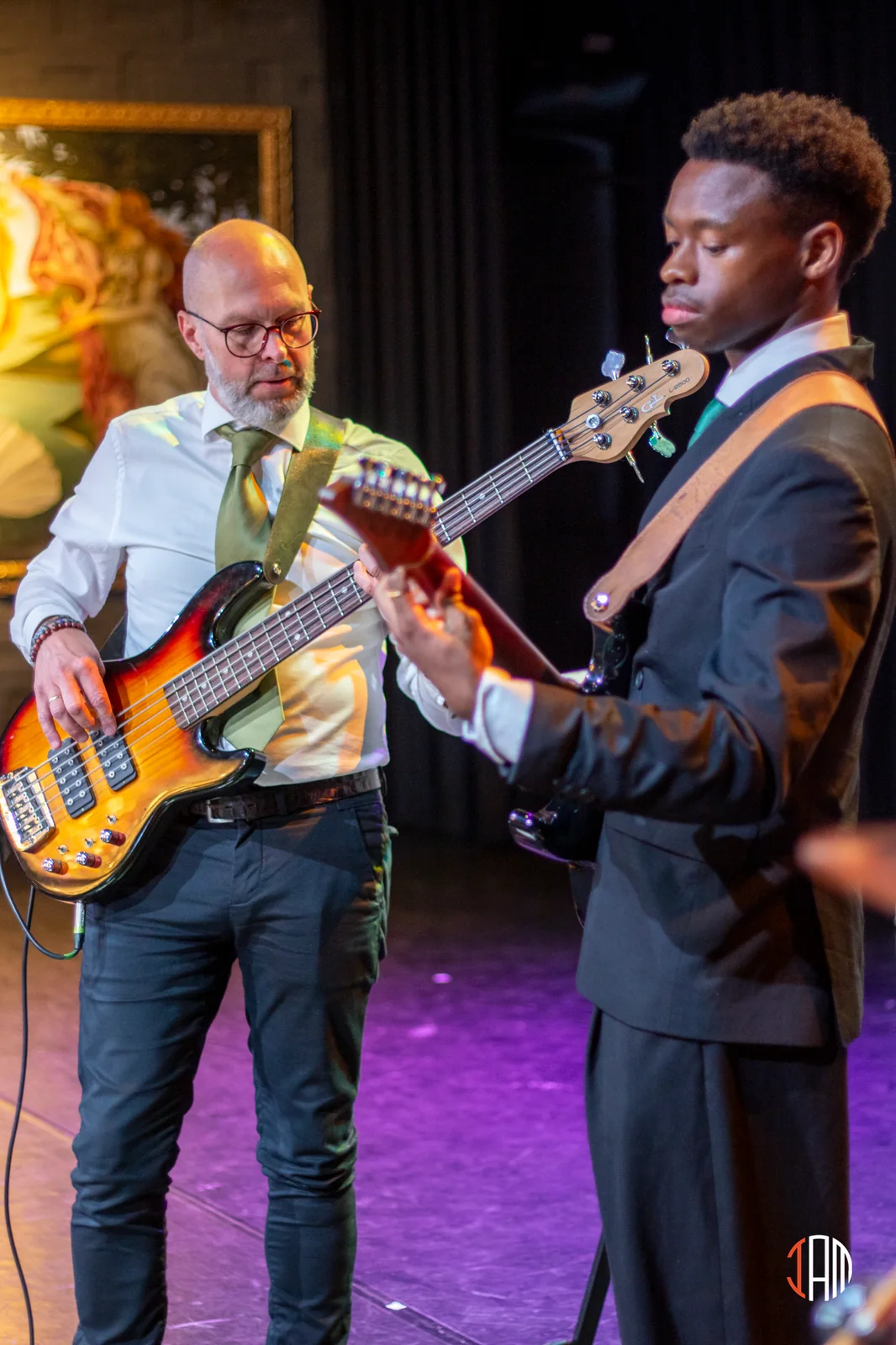 Two musicians playing bass and guitar