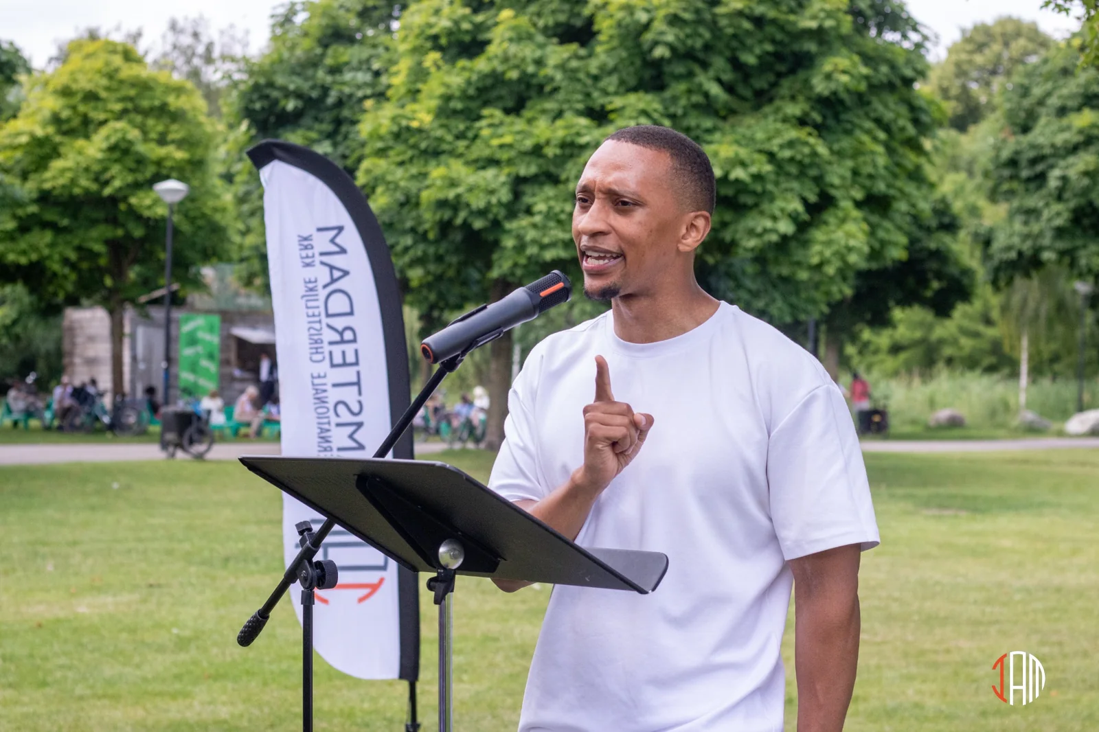 A man speaking at an outdoor church gathering