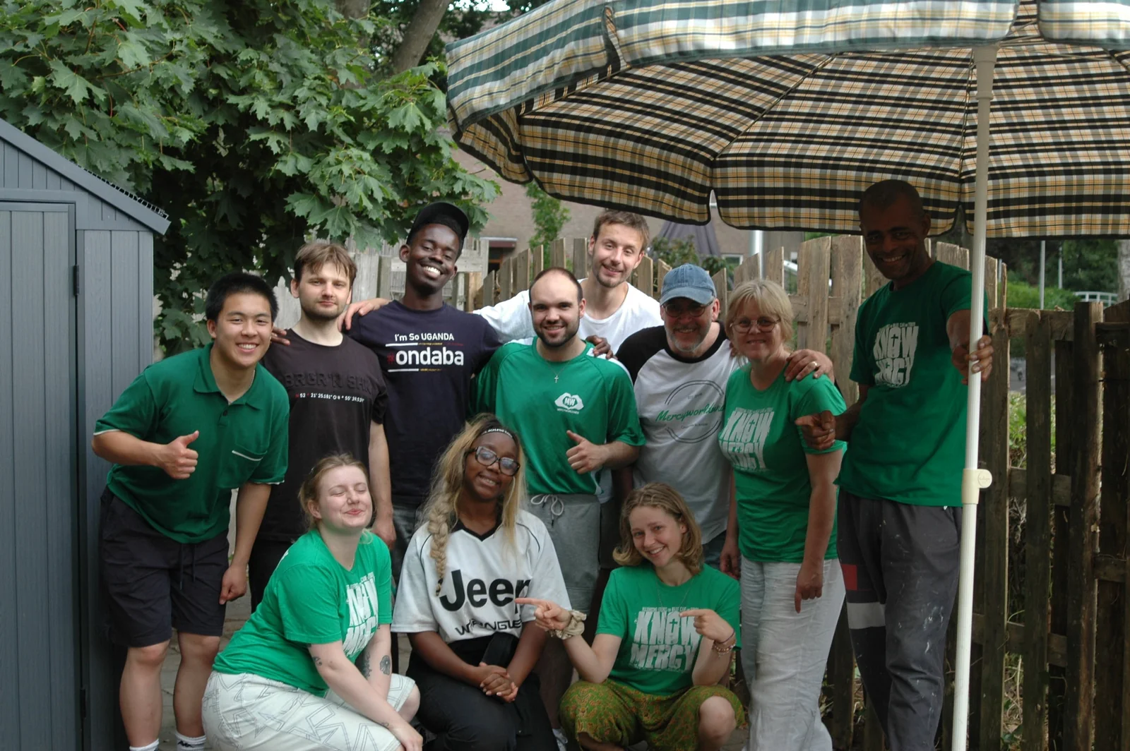 A group in MercyWorldwide shirts gathered outside